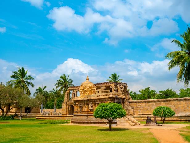 Brahadishwara Temple in Tanjore against a dazzling blue sky with wisps of cloud