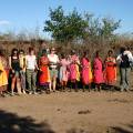 Masai Mara tribespeople standing in a row wearing colourful clothes