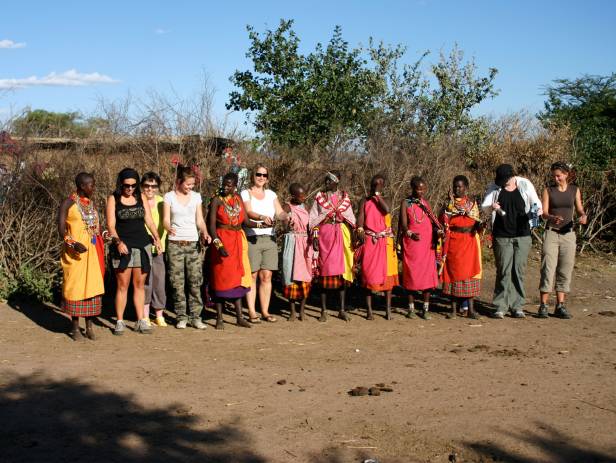Masai Mara tribespeople standing in a row wearing colourful clothes