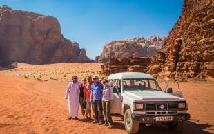 Group in front of jeep in Wadi Rum - Jordan Tours - On The Go Tours