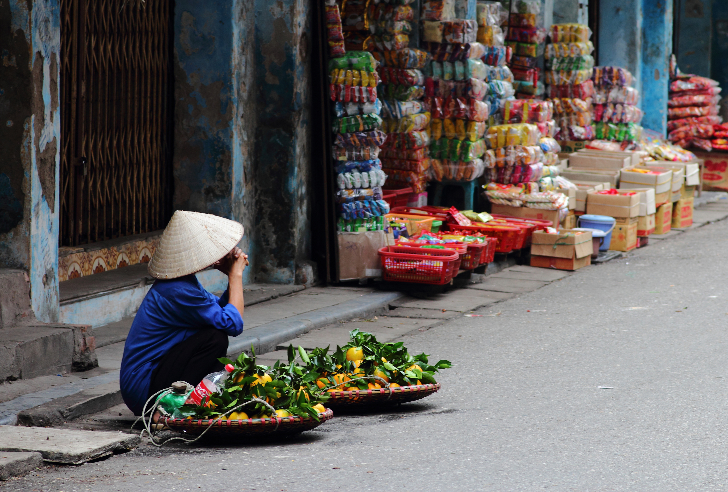 a man selling fruit on the streets of Hanoi