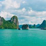The karst islands of Halong Bay rising from the vivid green waters