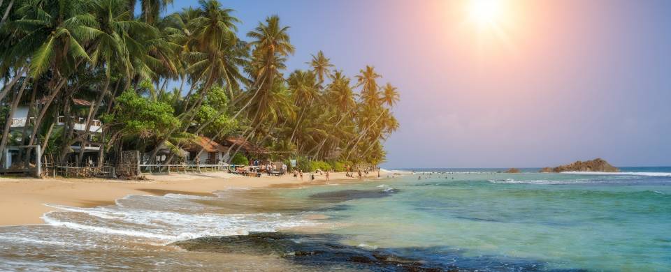 Sun shining down over the pristine beach in Hikkaduwa