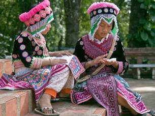 Hmong children in traditional clothes outdoors at Wat Doi Suthep in Chiang Mai, Thailand