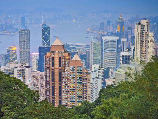 Train riding in front of the cityscape of Hong Kong