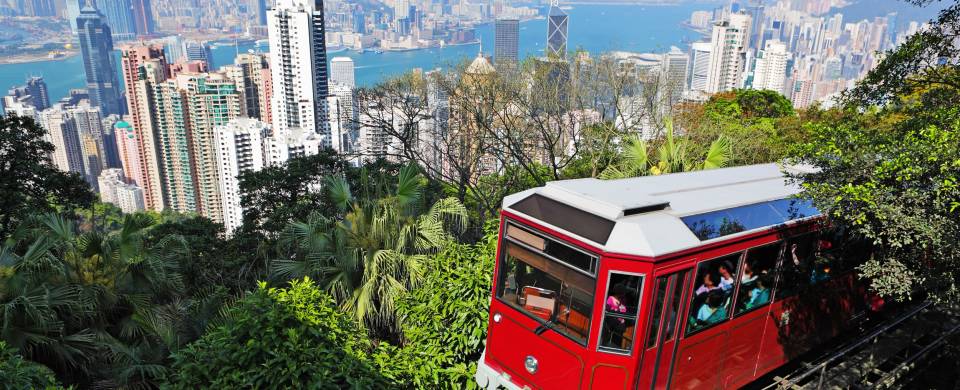 Train riding in front of the cityscape of Hong Kong