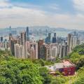 Train riding in front of the cityscape of Hong Kong