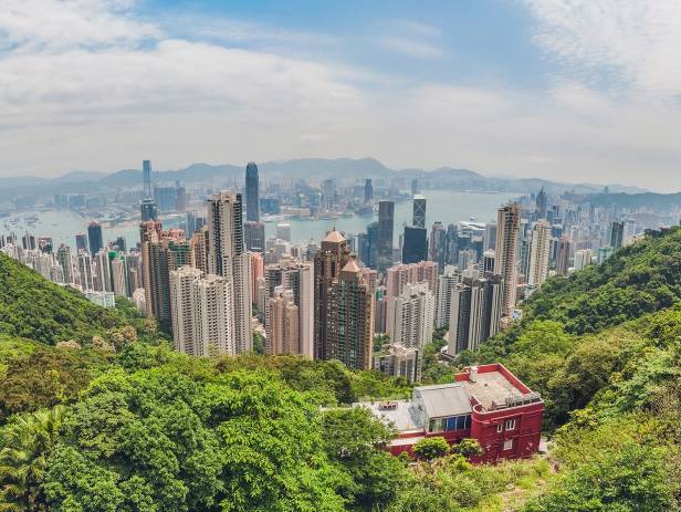 Train riding in front of the cityscape of Hong Kong