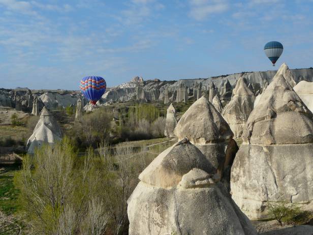 Hot air balloons floating over the stunning landscape of Cappadocia