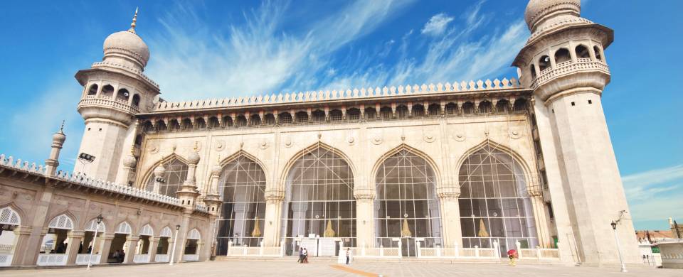 Mecca Masjid standing majestically against a blue sky in Hyderabad