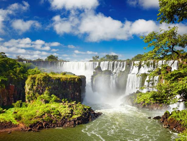 The majestic Iguazu falls creating white mist as they topple down