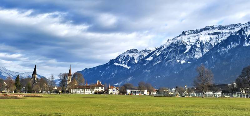 A panoramic view of Interlaken with snowcapped mountains in the background