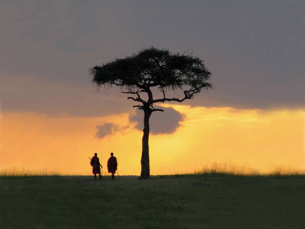 Masai Mara tribespeople standing in a row wearing colourful clothes