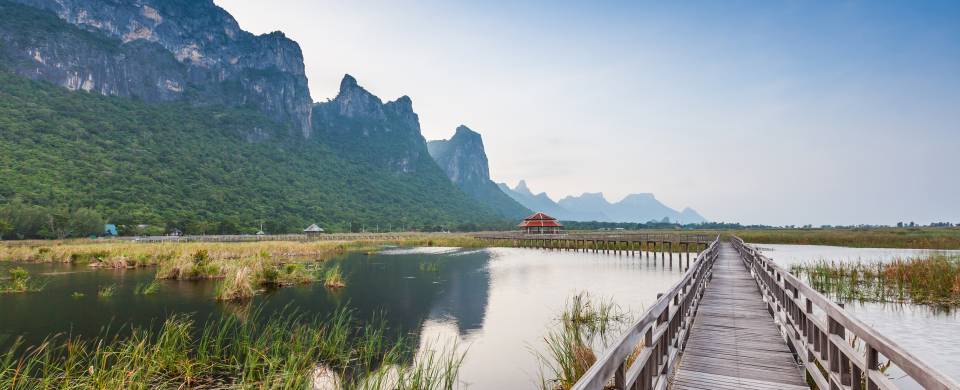 Boardwalk leading in to the distance, over the water and past mountains in Khao Sam Roi Yot National