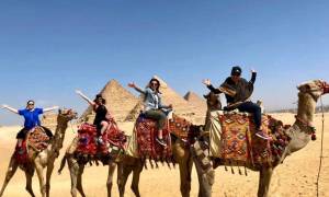 Ladies on camels at the Pyramids of Giza - Egypt - On The Go Tours