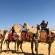 Ladies on camels at the Pyramids of Giza - Egypt - On The Go Tours
