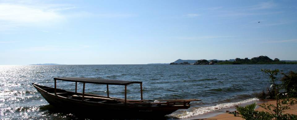 Boat sitting on the lake under a blue sky at Lake Victoria