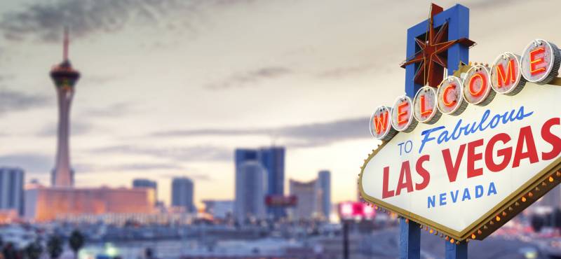 The 'welcome to Las Vegas' sign against a panoramic view of the city skyline