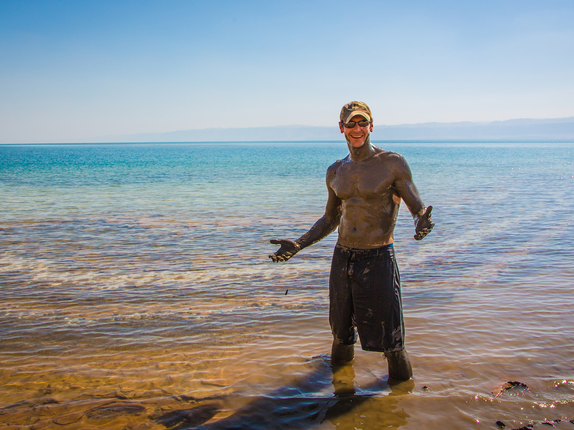 A man covered in Dead Sea mud