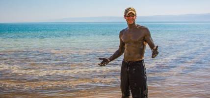 Man covered in Dead Sea mud - Jordan Tours - On The Go Tours copy