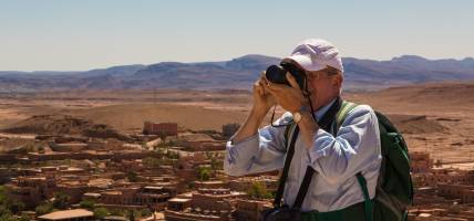 Man taking a photograph in Ait Benhaddou - Morocco Tours - On The Go Tours