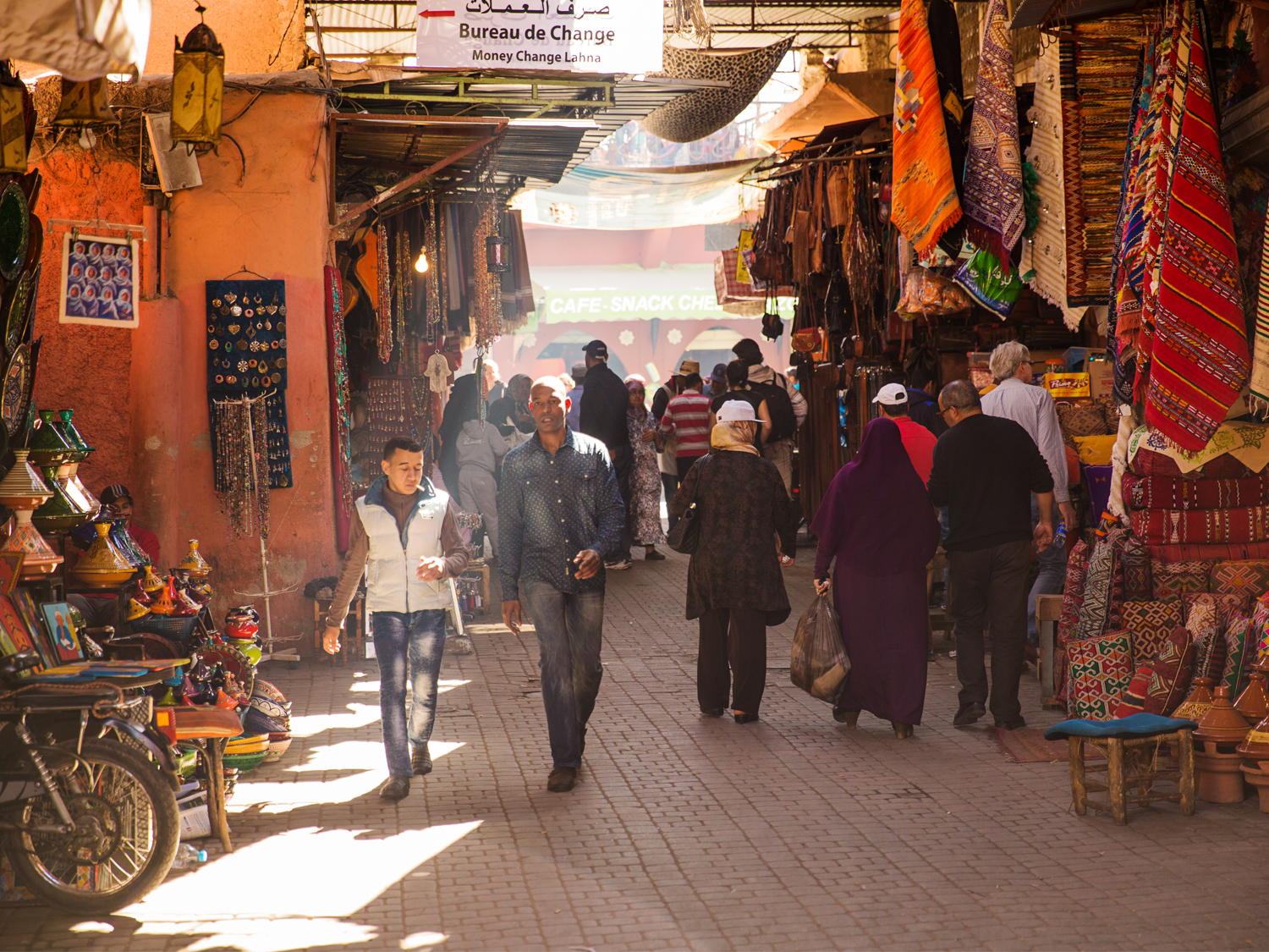 Two men walk through a souk in Marrakech, Morocco