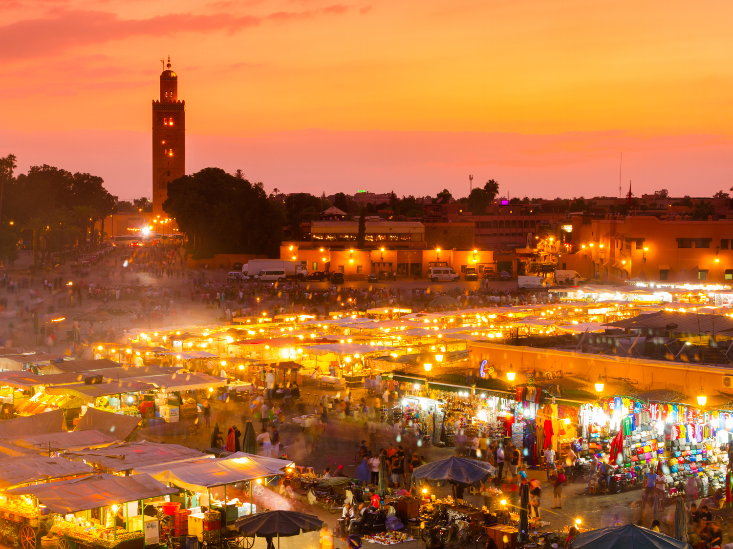 The skyline of Marrakech at sunset with the Koutoubia Mosque in the top left