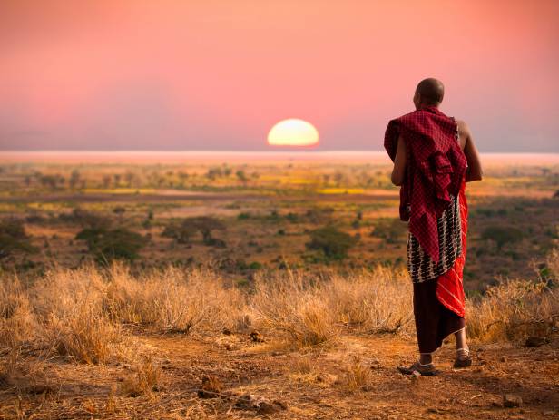 Masai Mara tribespeople standing in a row wearing colourful clothes