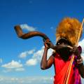 Masai Mara tribespeople standing in a row wearing colourful clothes