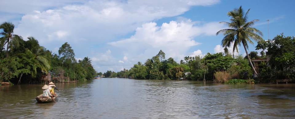 Boat rowing its way along the Mekong Delta