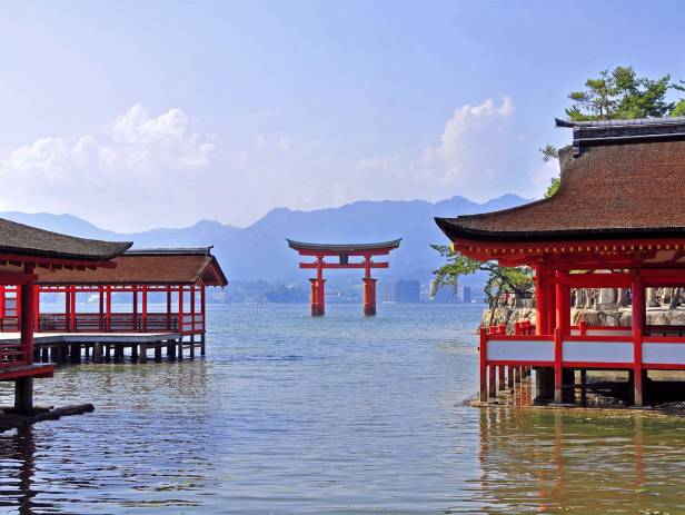 Sunset behind the iconic Miyajima monument that stands in the water