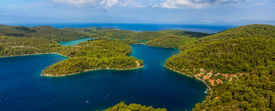 Perfect turquoise water speckled with islands, covered in thick, green foliage