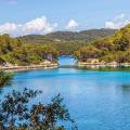 Perfect turquoise water speckled with islands, covered in thick, green foliage