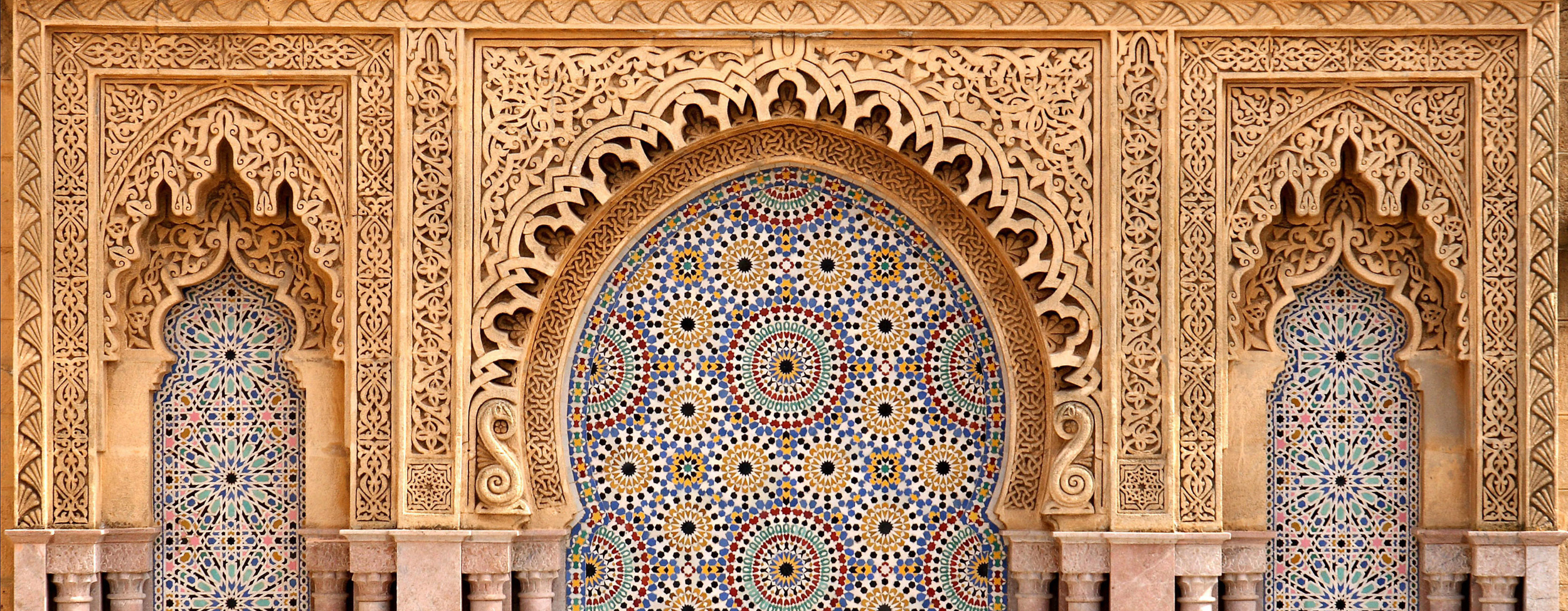 A Moroccan building with carvings and tiles
