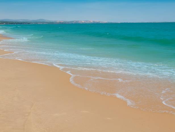 Hundreds of fishing boats floating on the turquoise water in Mui Ne