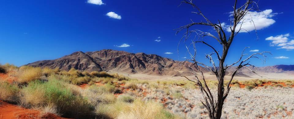 Orange sand dunes and rocky mountains at Namib Naukluft National Park