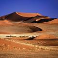 Orange sand dunes and rocky mountains at Namib Naukluft National Park