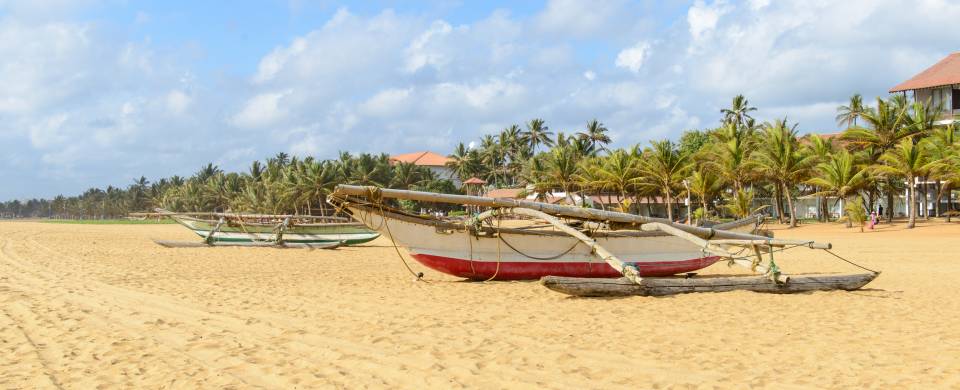 Traditional Sri Lankan fishing boat on the sandy beach in Negombo