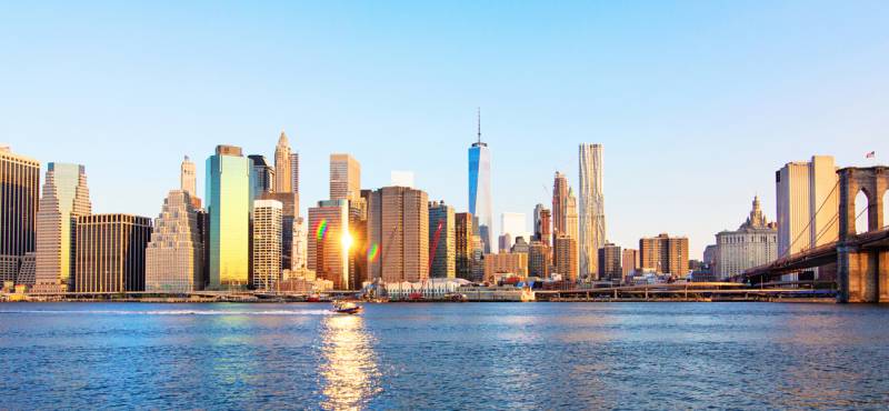 A panoramic view of the iconic Manhattan skyline on a bright sunny day in New York