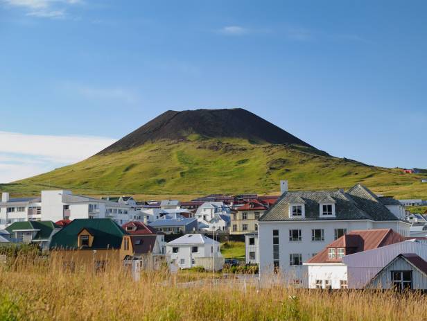 Horses grazing in front of the Helka stratovolcano near Hella