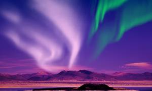 Northern Lights against purple sky - Iceland - On The Go Tours