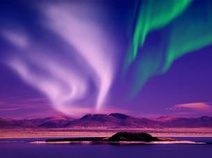 Northern Lights against purple sky - Iceland - On The Go Tours