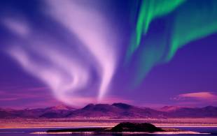 Northern Lights against purple sky - Iceland - On The Go Tours