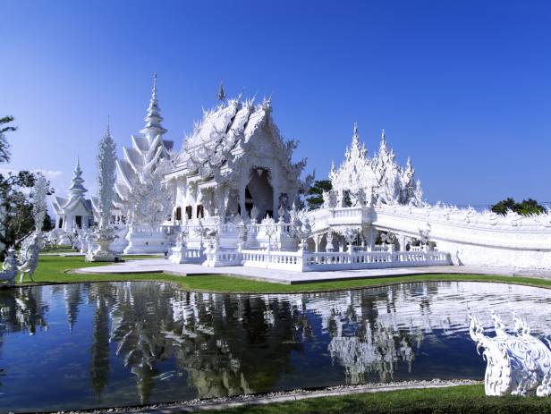 White Buddha statue in front of one of the many temples of Chiang Mai