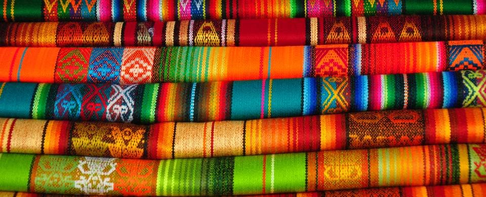 Brightly coloured textiles at a market in Otavalo