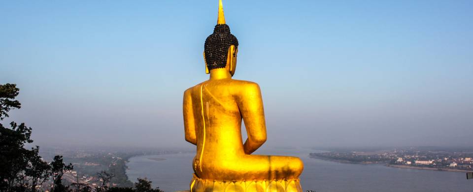 The golden Big Buddha Temple sitting atop a hill and looking out over the city of Pakse