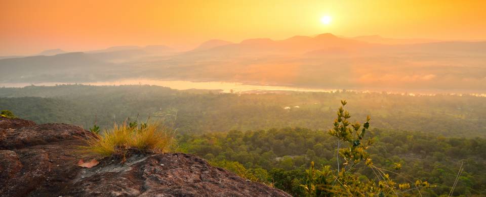 Stunning sunset painting the sky orange over Pha Taem National Park