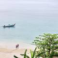 Traditional Thai boats rest in the clear waters of Phuket island