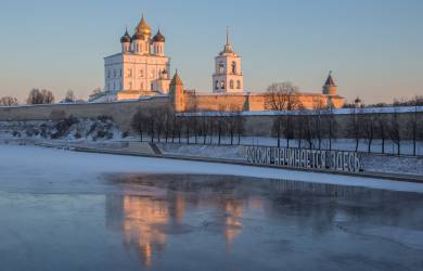 Pskov Kremlin beside the frozen-over river during the winter months in Russia