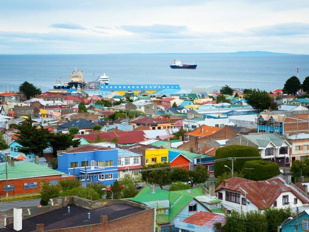 Scenic view of Punta Arenas - colourful houses and a boat in the background